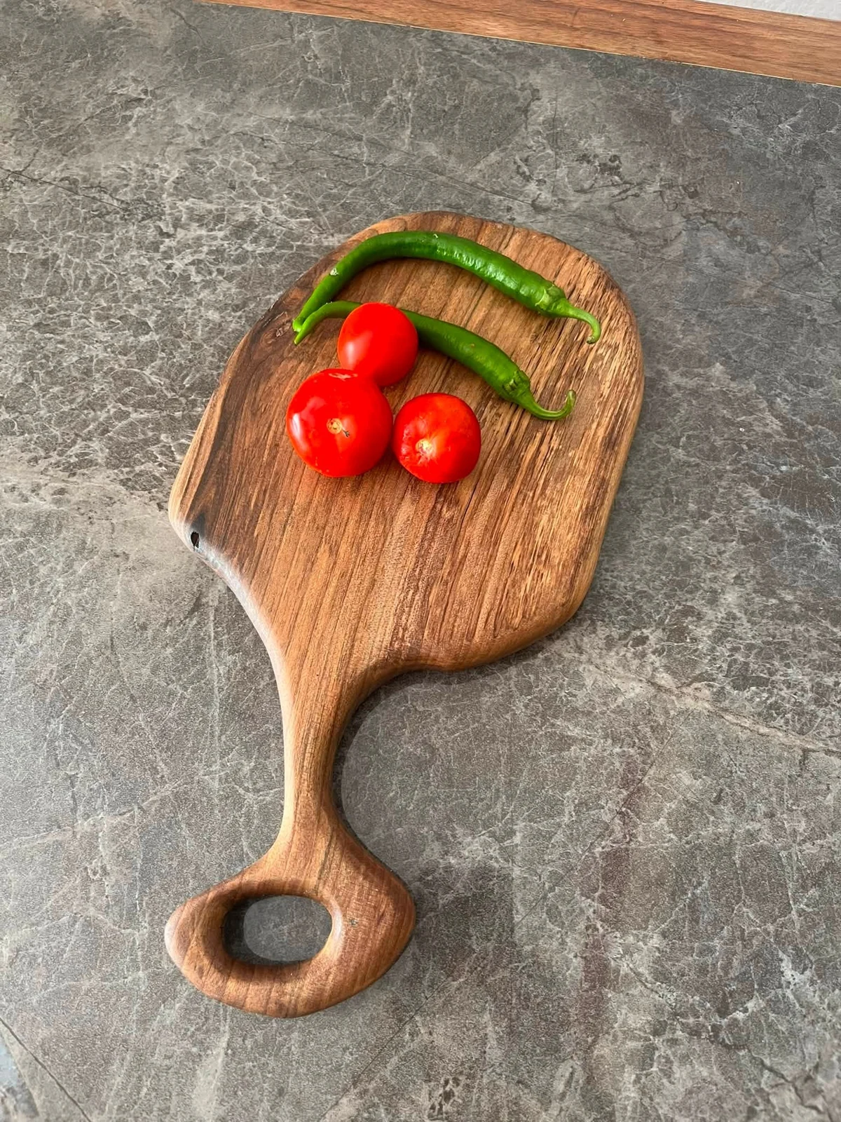 Original workshop reference photograph of the organic walnut paddle cutting board; one board supplied