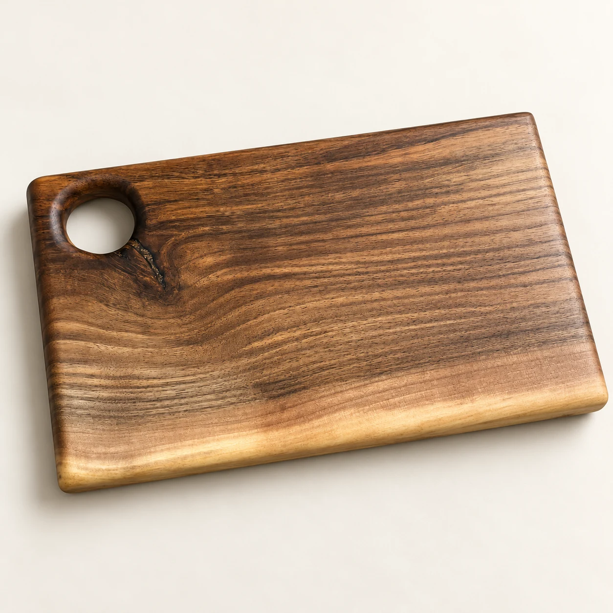 catalog view of the walnut cutting board with corner hole on a neutral background
