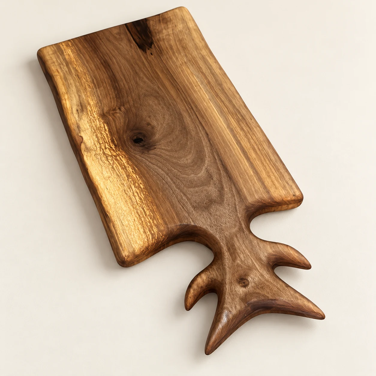 catalog view of the walnut cutting board with sculpted handle on a neutral background
