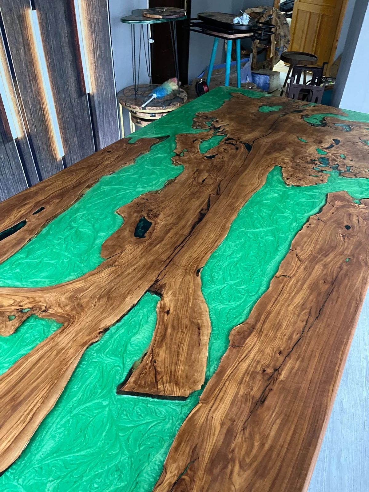 Lengthwise view of natural wood sections embedded in green resin