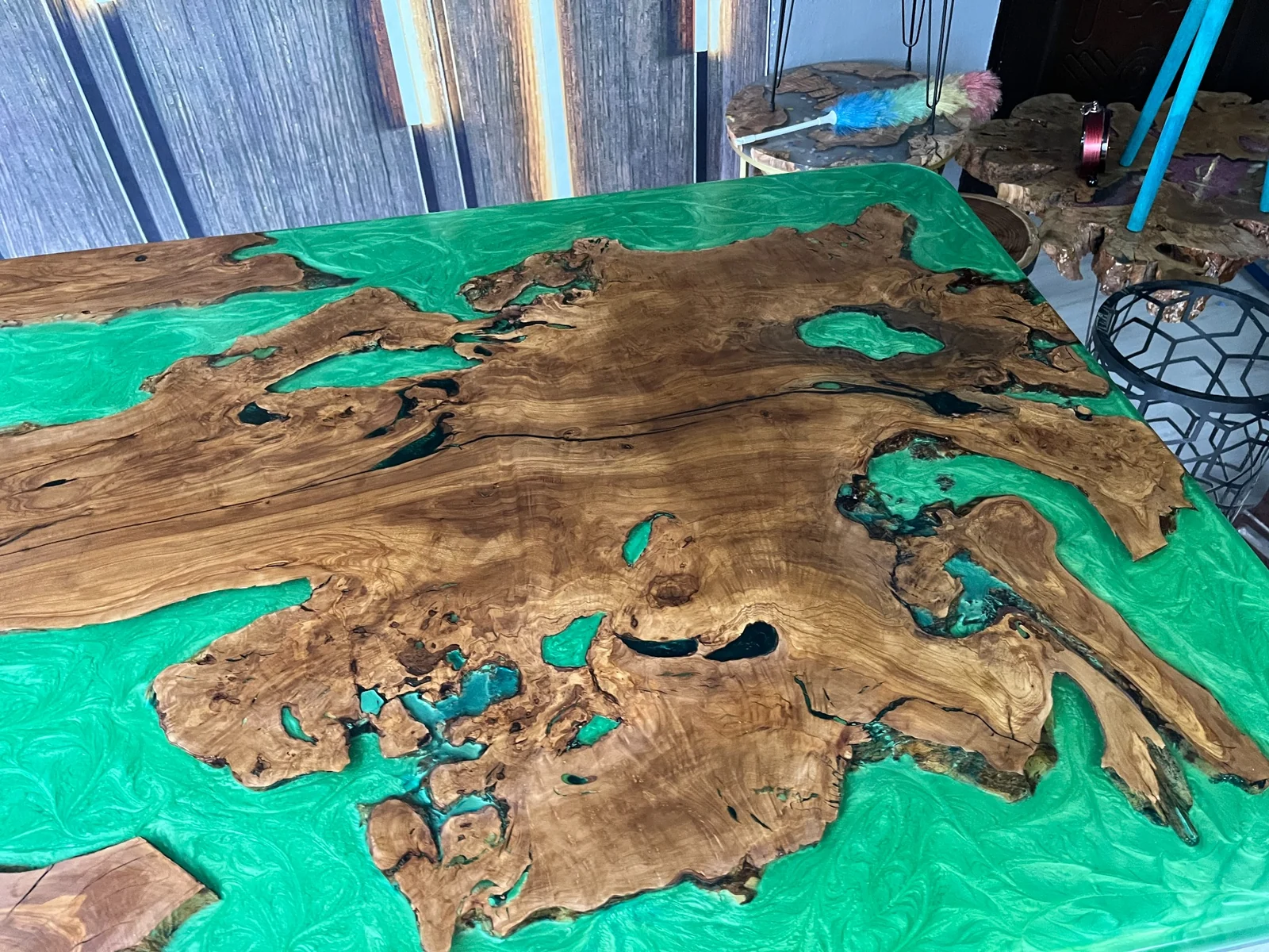 Close-up of irregular natural wood islands surrounded by swirling green epoxy
