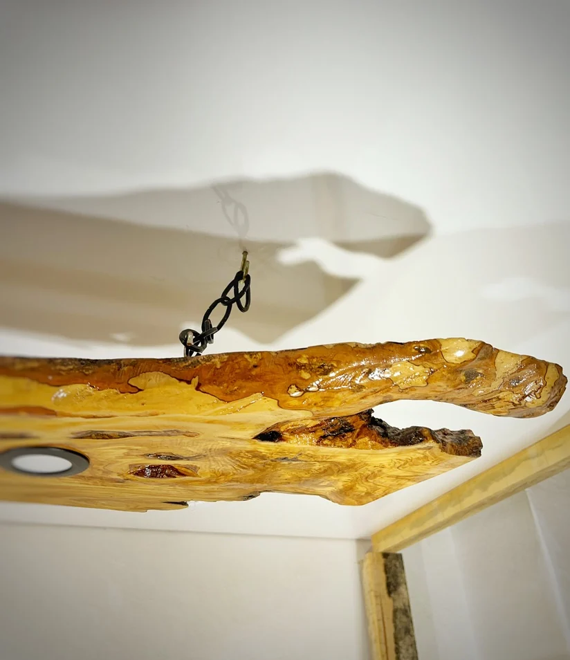 Original side view showing black chain suspension and the natural olive wood edge
