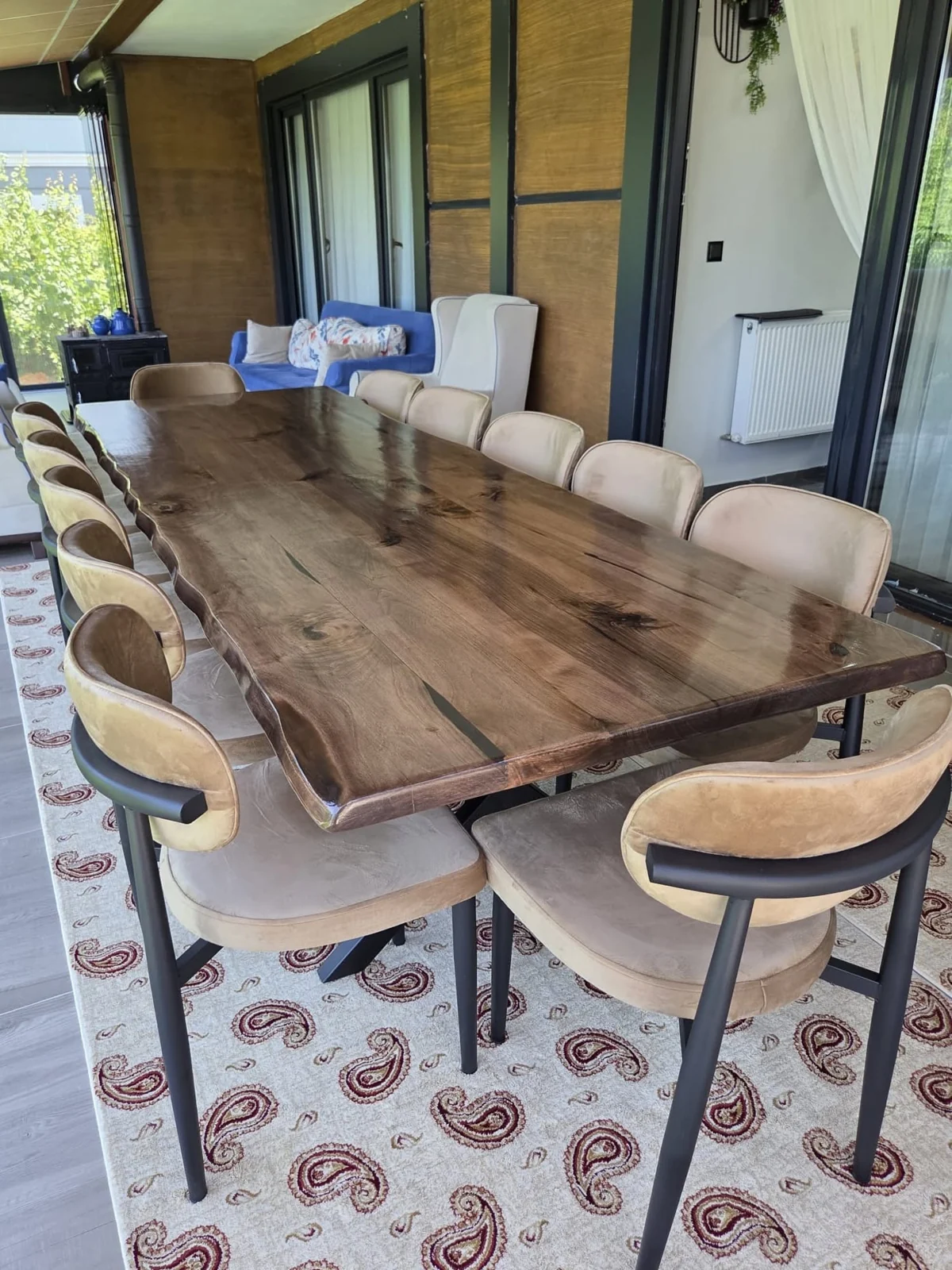 Live edge walnut dining table with rich brown grain in a furnished room; chairs not included
