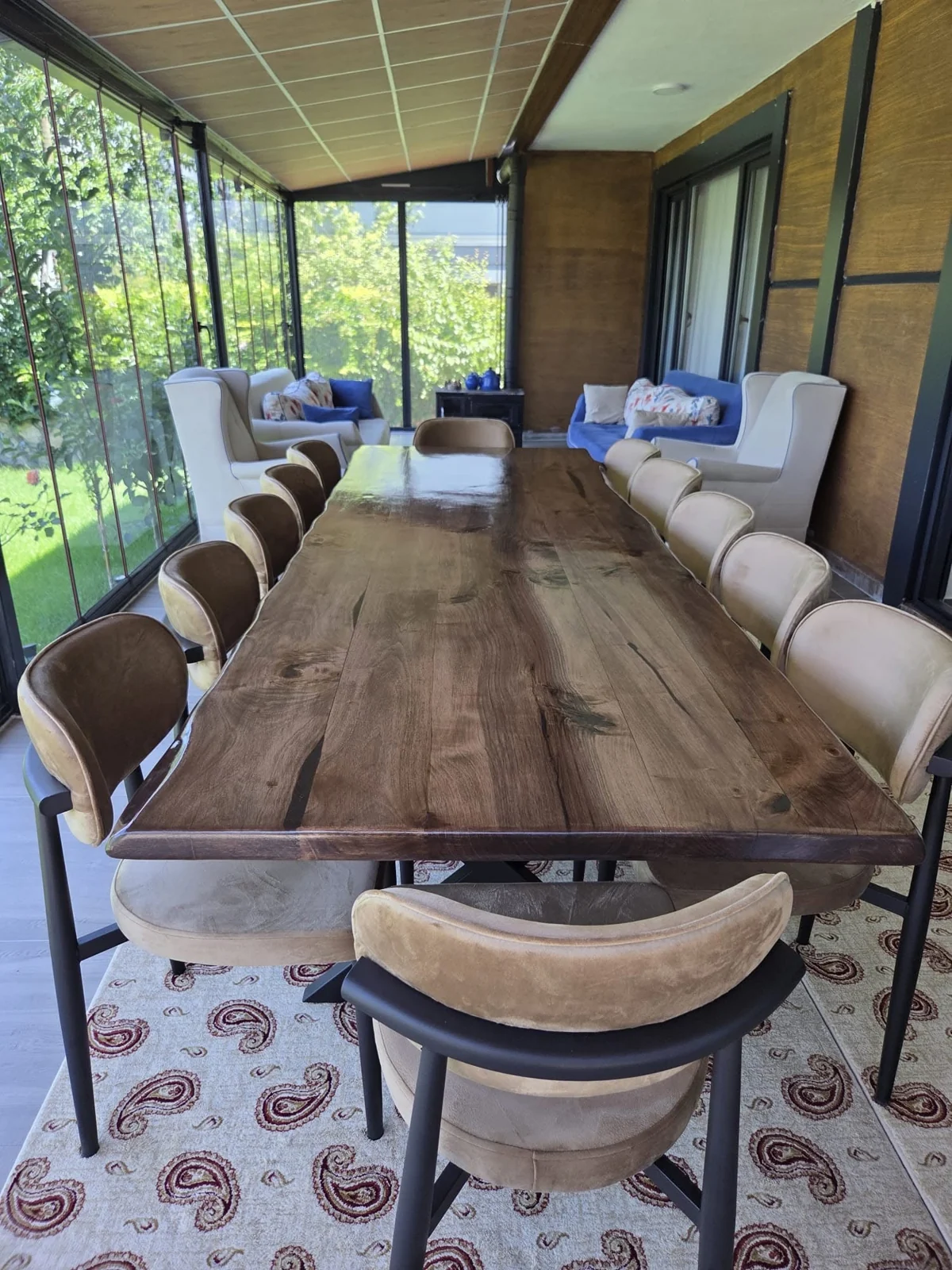 Long walnut dining tabletop showing natural grain and irregular wood edges; chairs not included