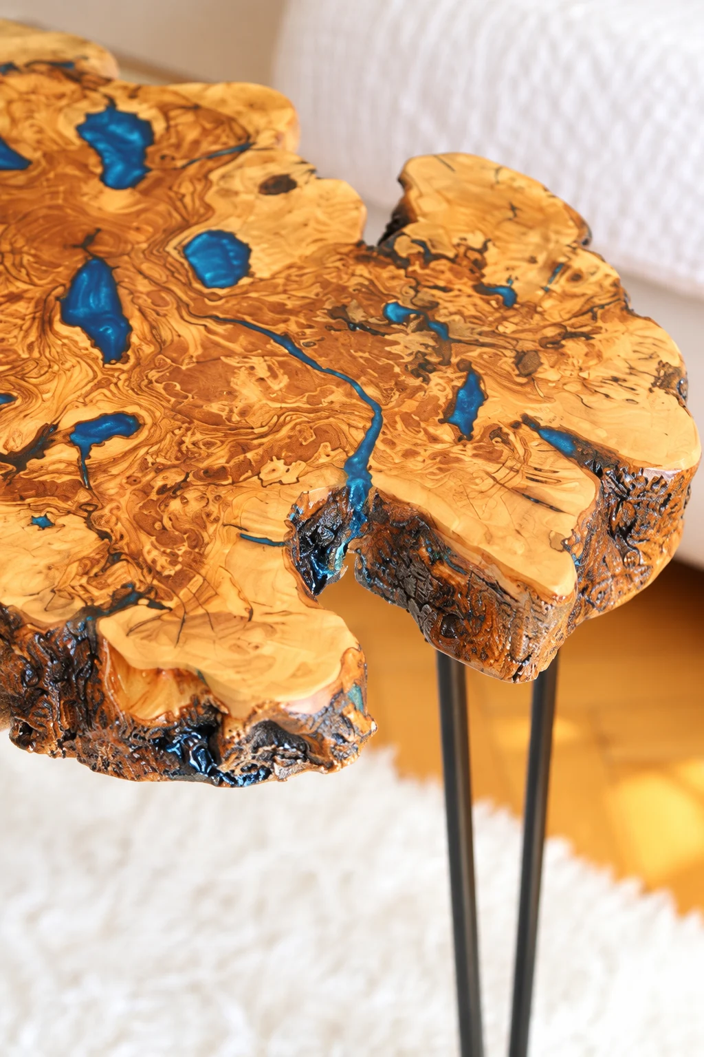Digitally enhanced close-up reference of the natural olive slab edge and blue resin-filled cracks
