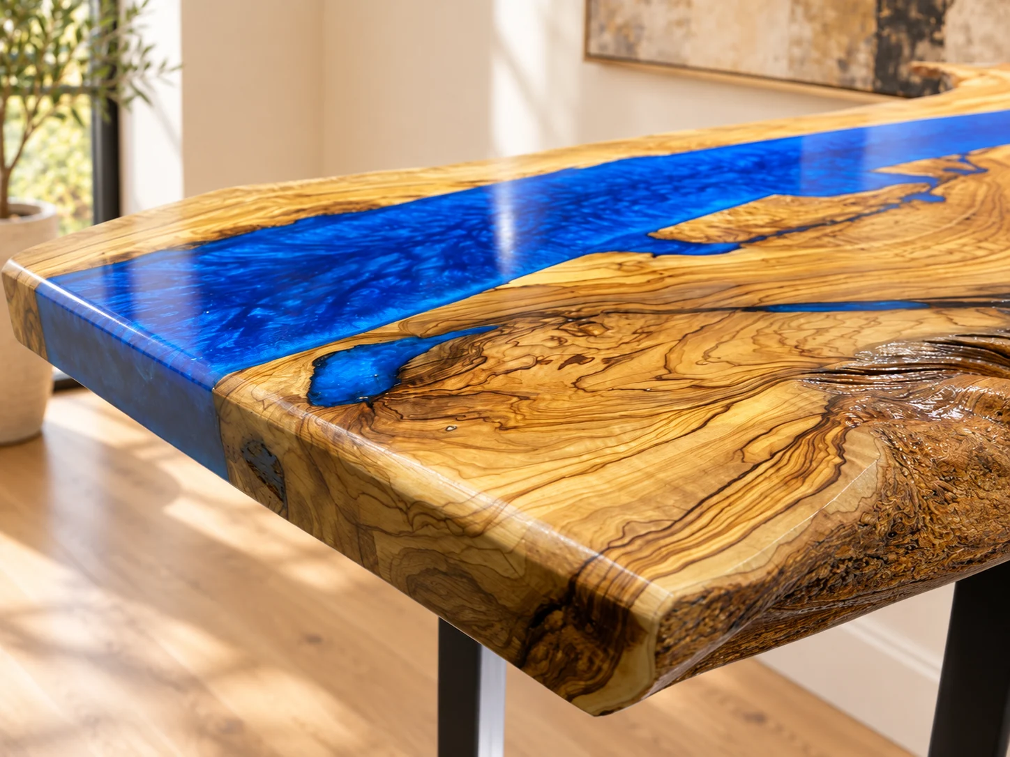 Close-up of olive wood grain and blue epoxy river in a digitally styled room