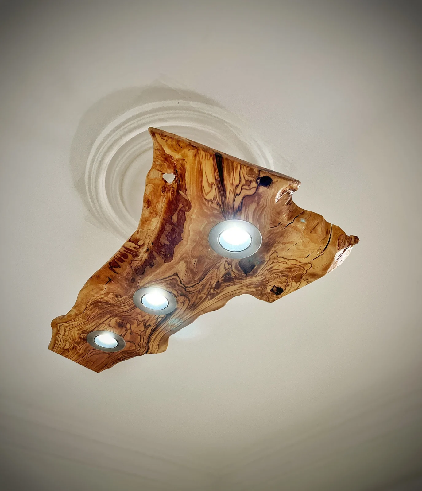 Olive wood live edge ceiling light with three recessed spotlights illuminated