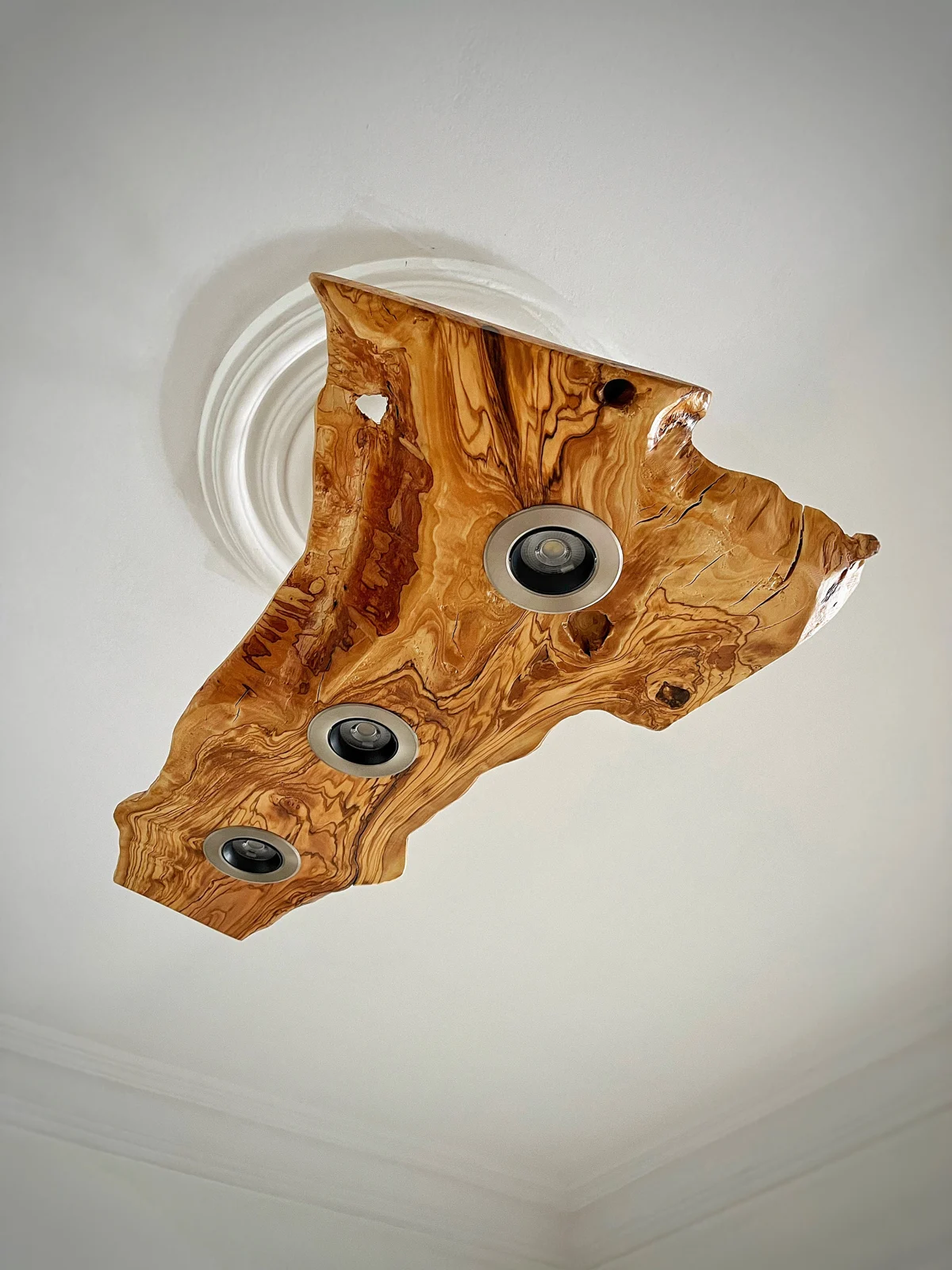Side view of the olive wood ceiling fixture with three inset spotlights