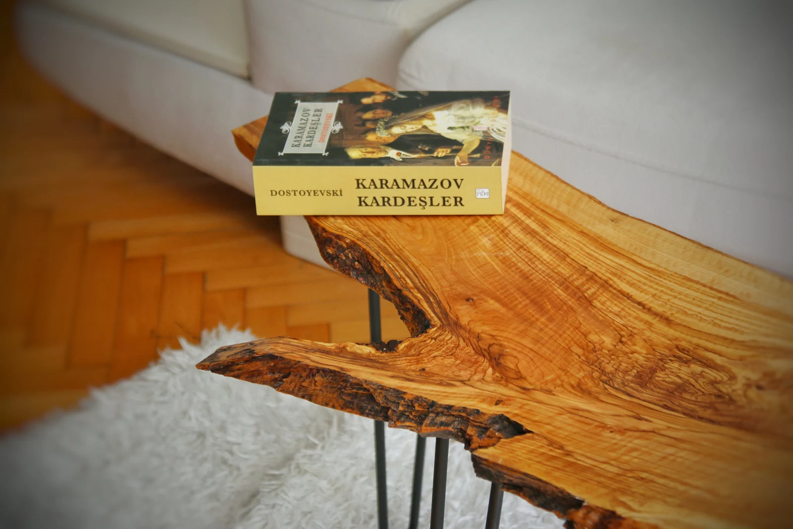 Angled detail of the olive wood tabletop and sculptural live edge