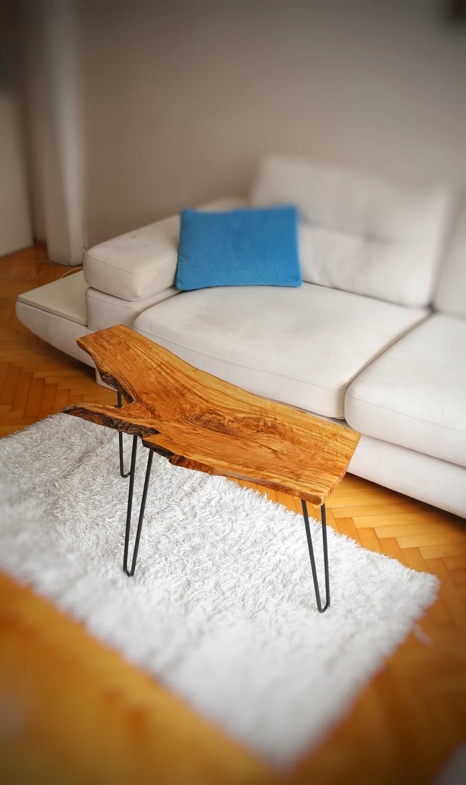 Handmade olive wood coffee table with hairpin legs in a living room