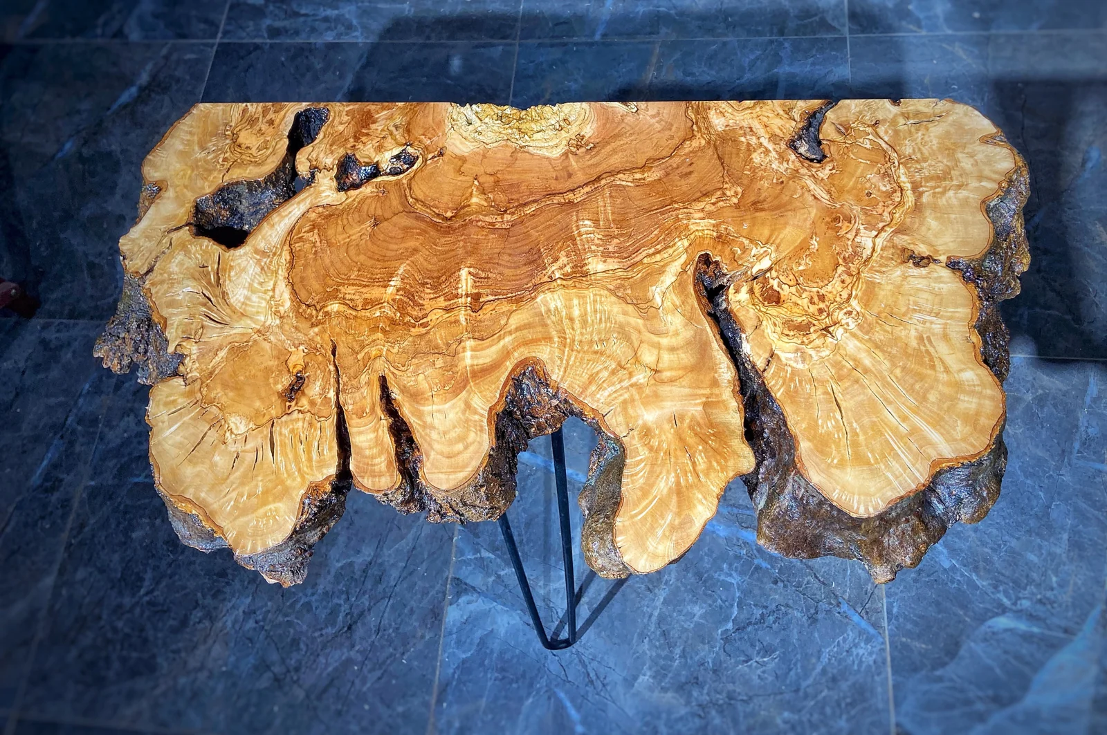 Overhead view of the olive console slab showing flowing grain and natural fissures