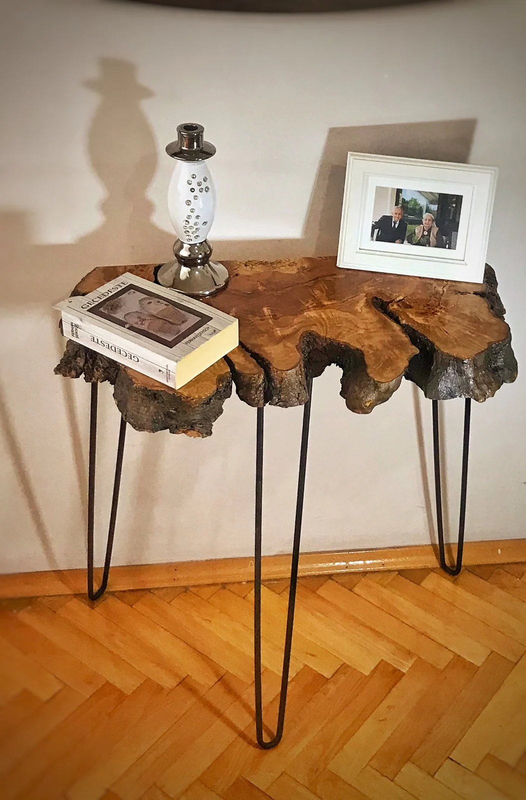 Olive wood console table styled with a lamp, books and frame; decorative items not included