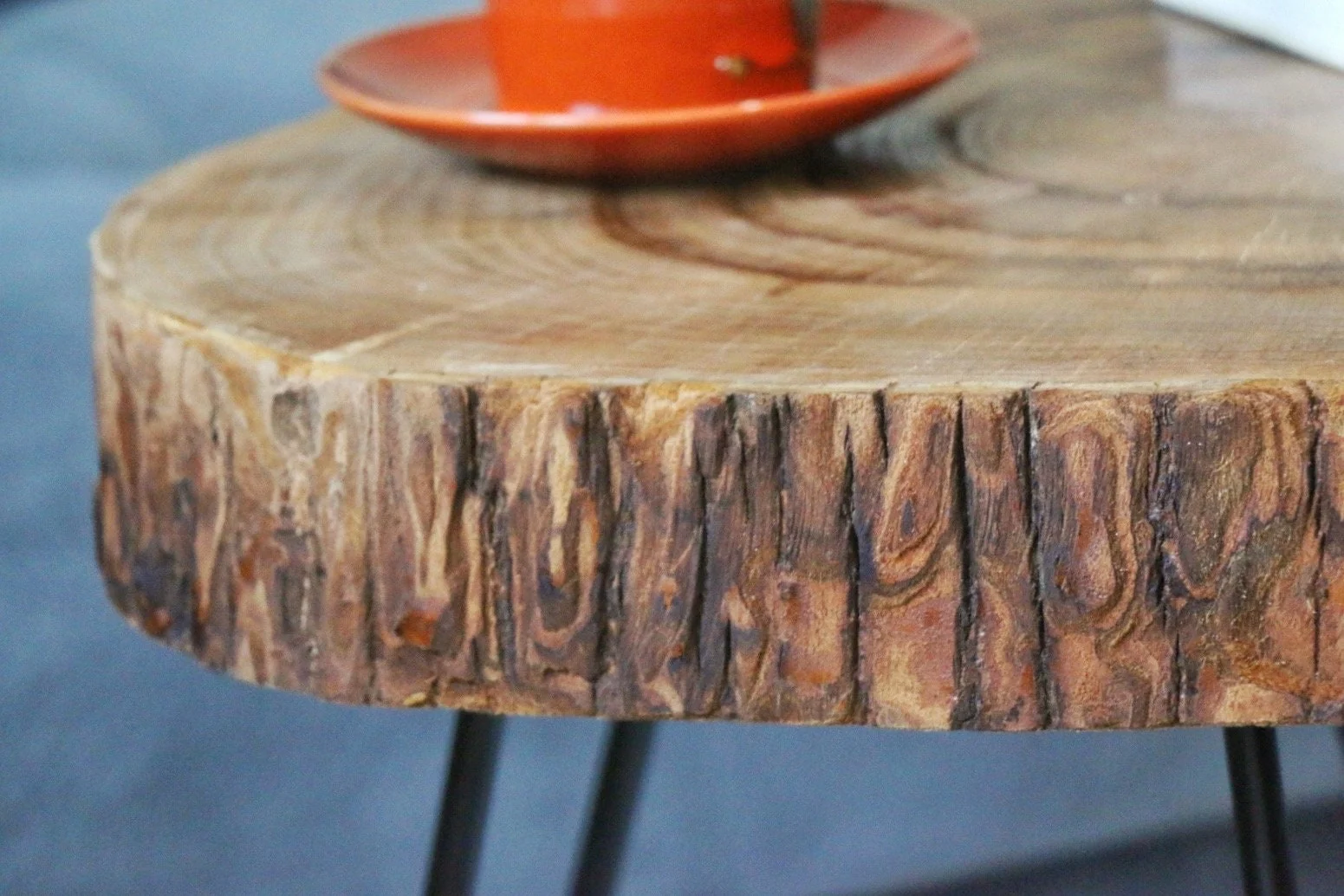 Close-up of the textured bark edge on a round walnut tree slice tabletop
