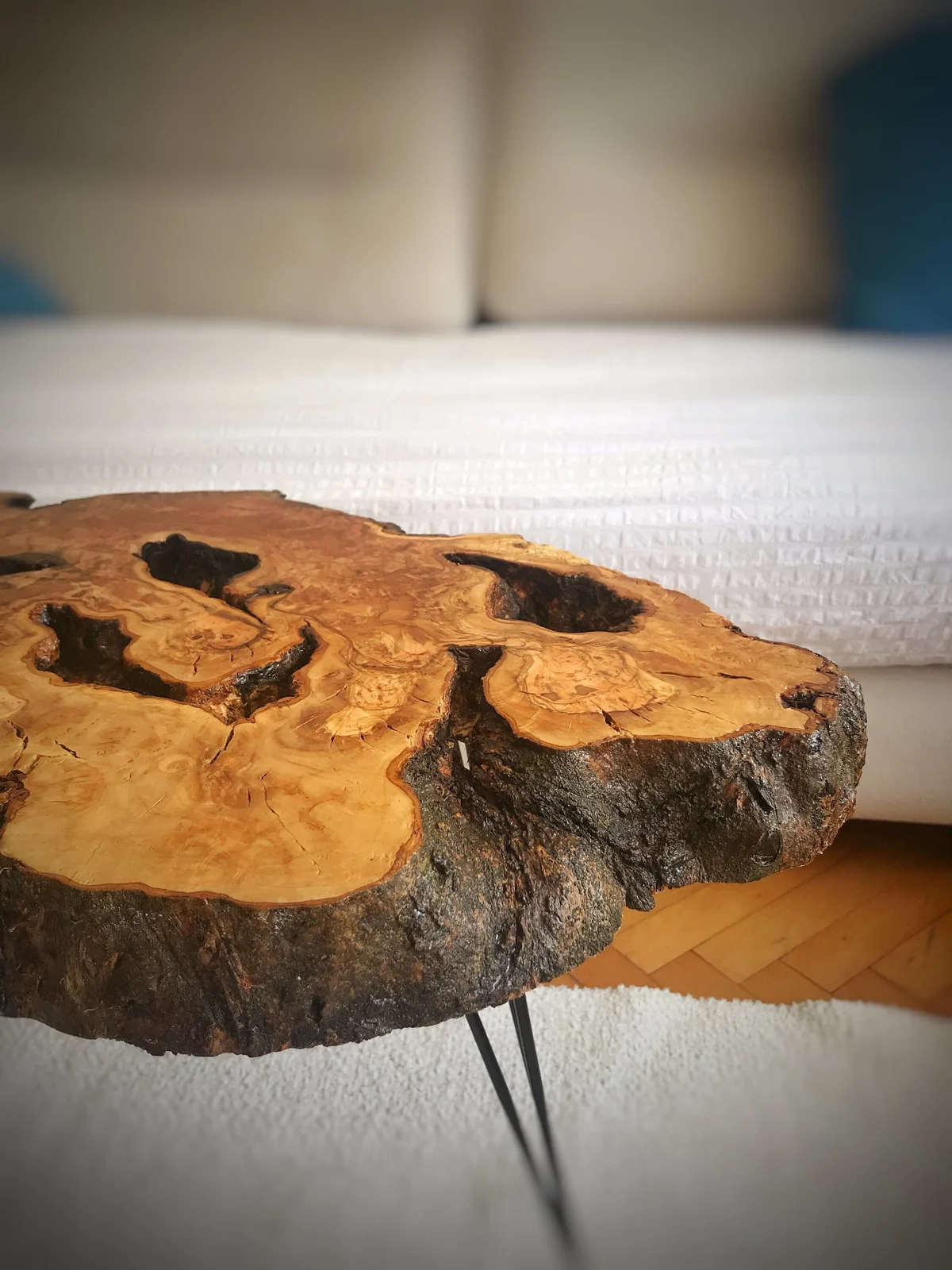 Close-up of the olive wood coffee table grain, bark edge and slab thickness