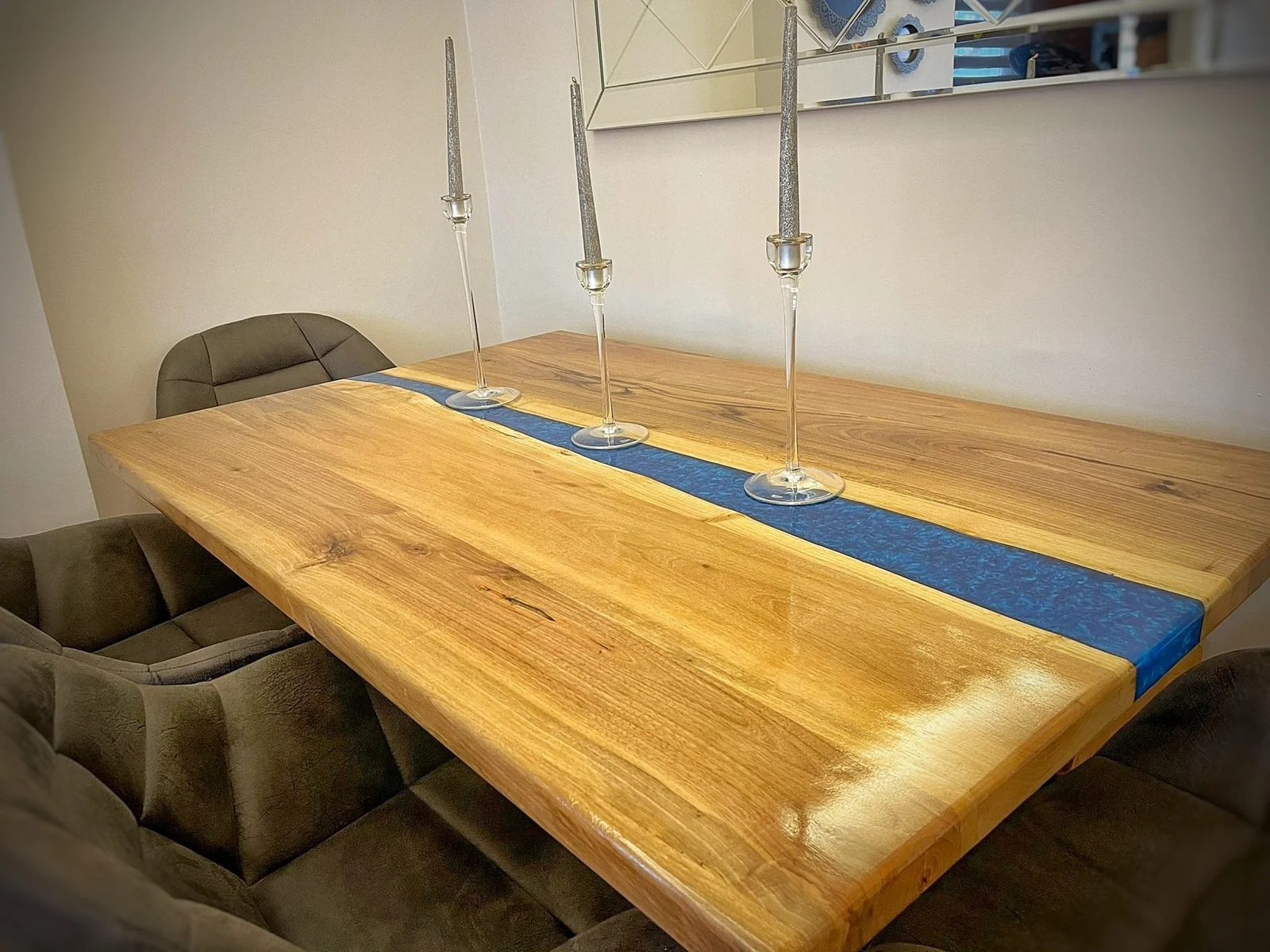 Original close-up of wood grain and blue epoxy dining tabletop with candleholders