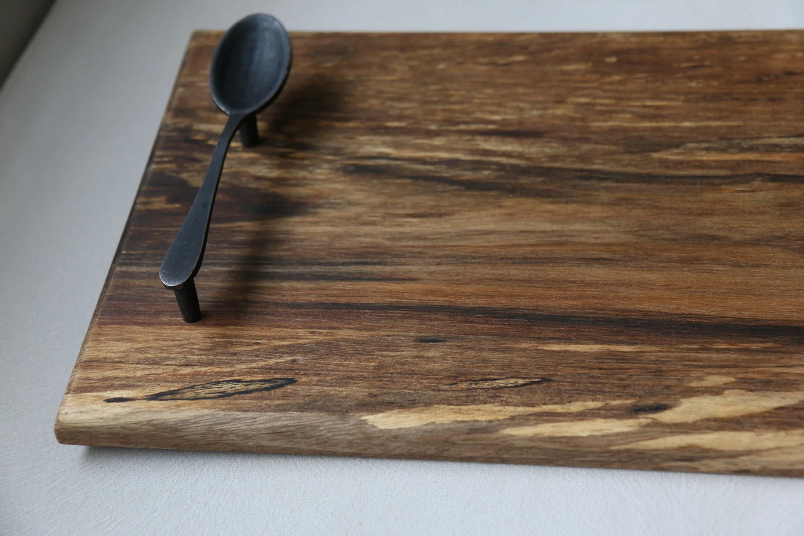 Close-up of the walnut board corner, grain and natural edge